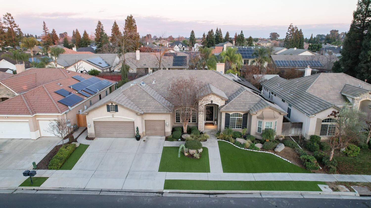 1081 North Harvard Avenue Clovis, CA 93611 - Photo 49 of 57 a front view of a house with a garden and plants