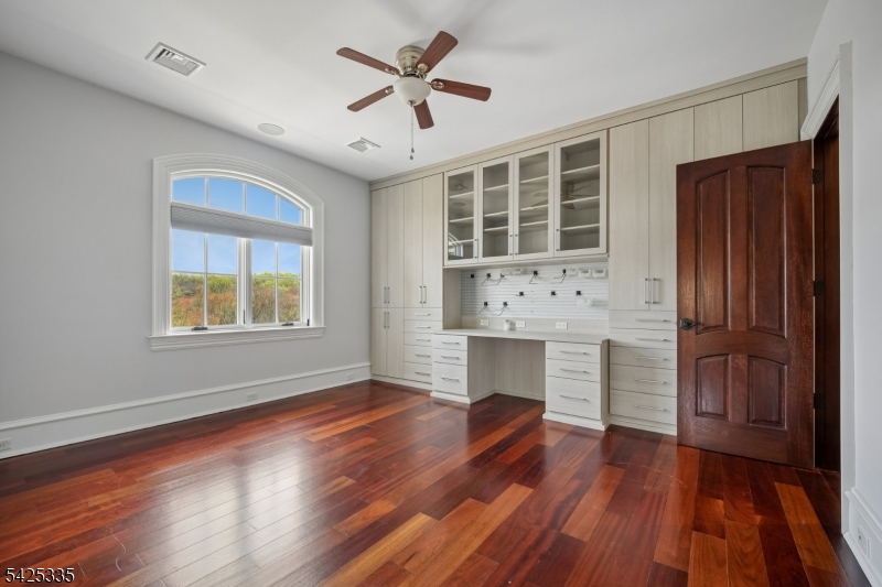 318 Franklin Road Denville, NJ 07834 - Photo 21 of 40 a view of a livingroom with wooden floor and a ceiling fan