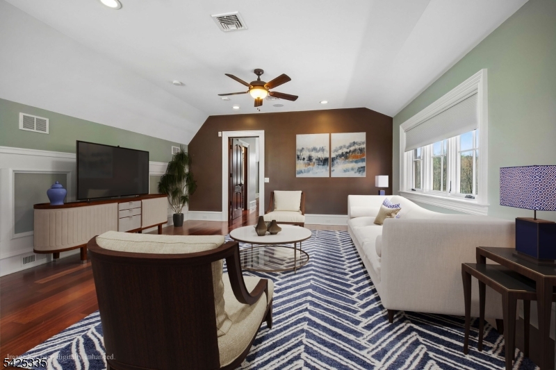 318 Franklin Road Denville, NJ 07834 - Photo 25 of 40 a living room with furniture a flat screen tv and a dining table