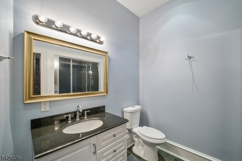318 Franklin Road Denville, NJ 07834 - Photo 29 of 40 a bathroom with a granite countertop sink vanity mirror and toilet