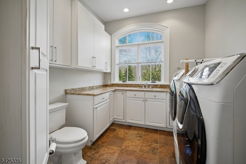 318 Franklin Road Denville, NJ 07834 - Photo 31 of 40 a kitchen with a white cabinets sink and a window