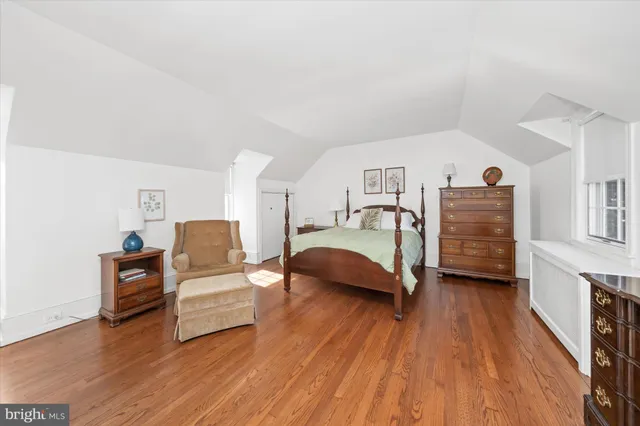 a bedroom with furniture and a wooden floor