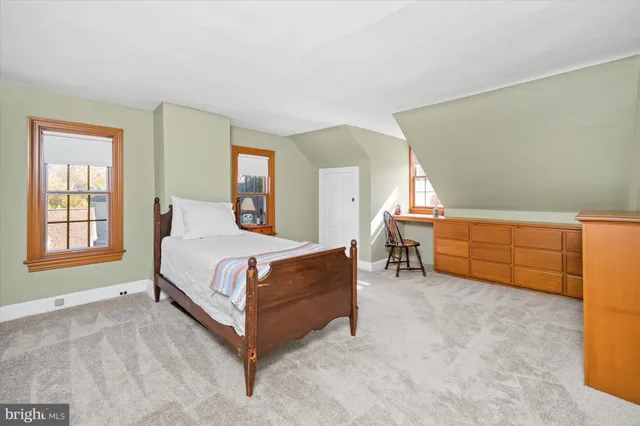 a spacious bedroom with a bed and a window