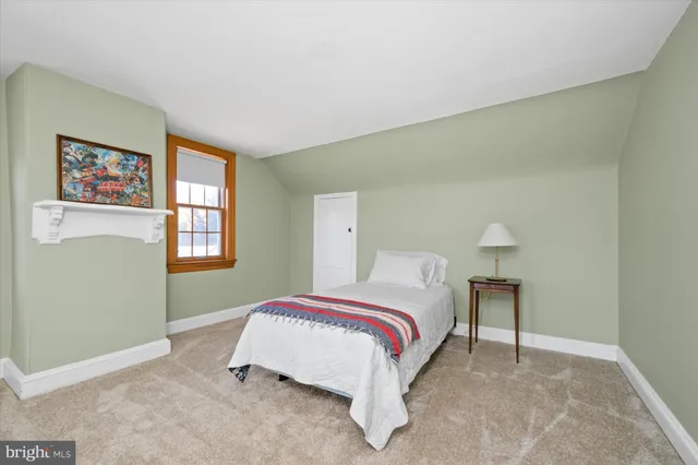 a bed room with a bed and a chair