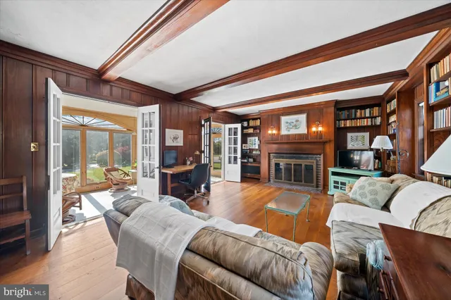 a living room with furniture a fireplace and a large window
