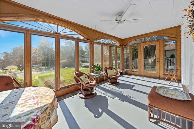 a living room with furniture and floor to ceiling windows