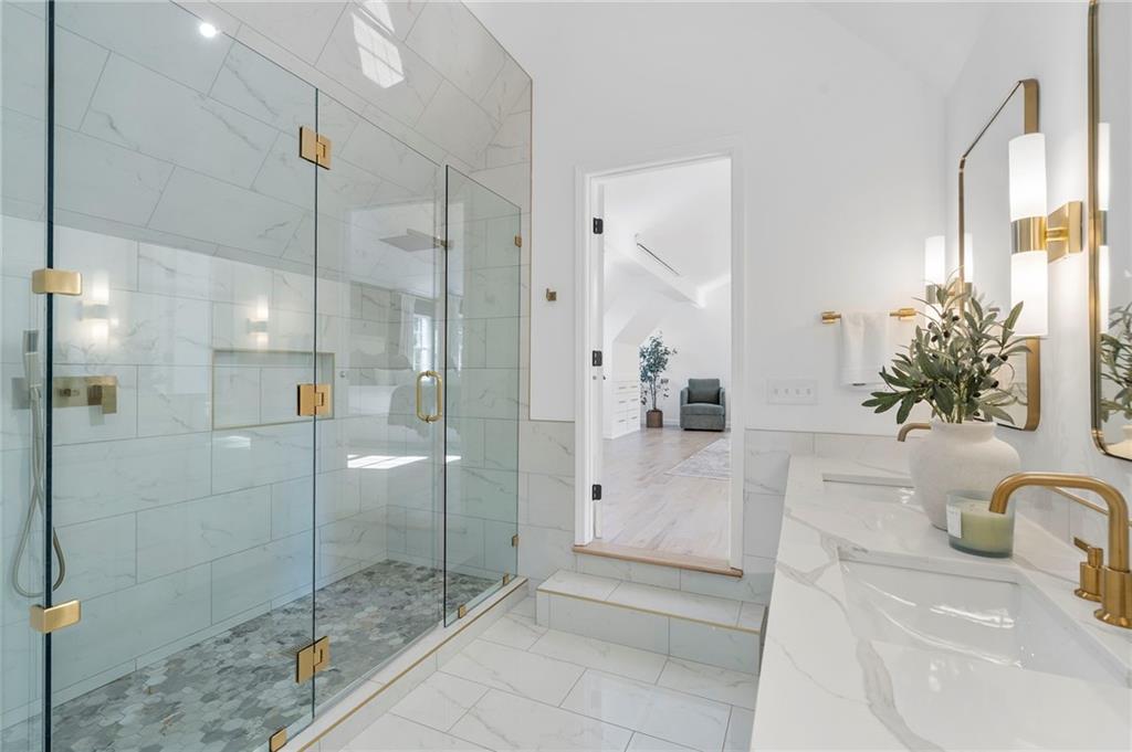 403 Rockbridge Road Southwest Lilburn, GA 30047 - Photo 45 of 77 a bathroom with a tub sink and mirror