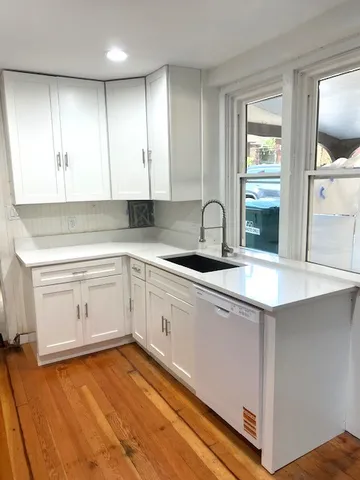a kitchen with a sink cabinets and window