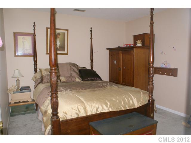 12 Friendfield Court Fort Mill, SC 29715 - Photo 11 of 15 a bedroom with a bed and wooden floor