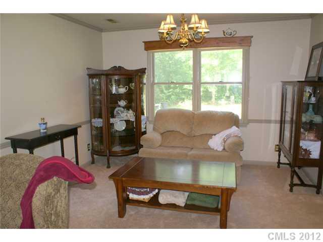 12 Friendfield Court Fort Mill, SC 29715 - Photo 3 of 15 a living room with furniture a window and a flat screen tv