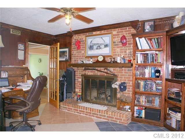 12 Friendfield Court Fort Mill, SC 29715 - Photo 4 of 15 a living room with fireplace furniture and a bookshelf