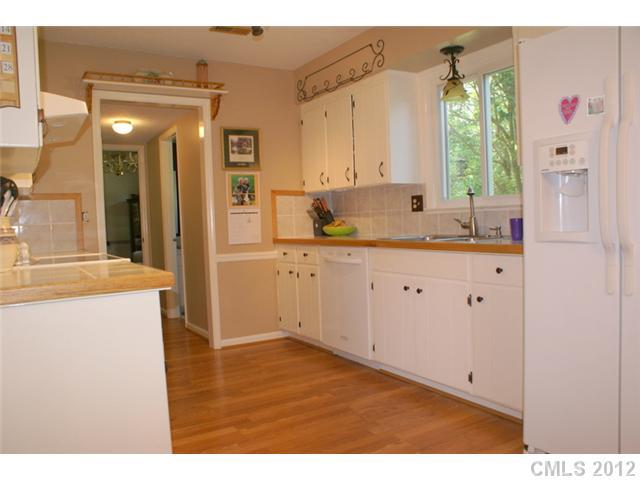 12 Friendfield Court Fort Mill, SC 29715 - Photo 6 of 15 a kitchen with a sink a window and cabinets
