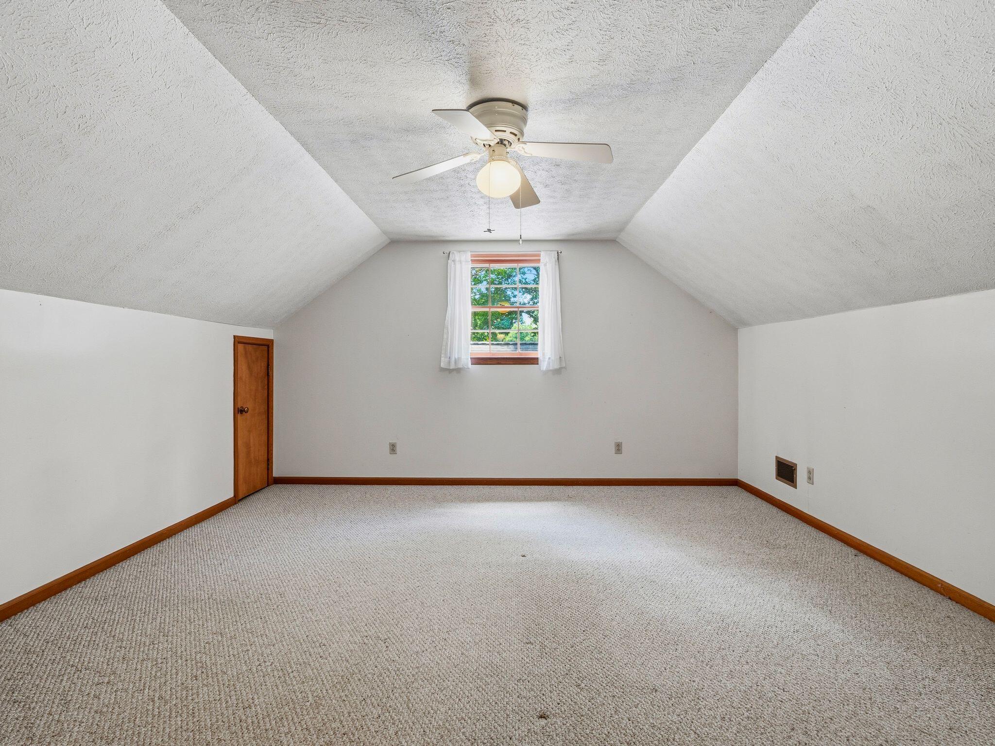 1115 Robin Ridge Road Henry, VA 24102 - Photo 28 of 54 an empty room with a window and a ceiling fan