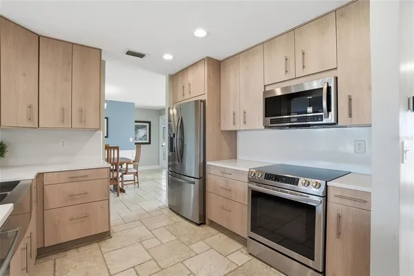 a kitchen with stainless steel appliances a stove a microwave and a refrigerator