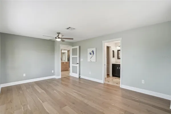 a view of an empty room with wooden floor