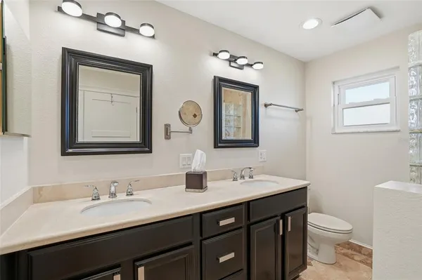 a bathroom with a double vanity sink and a mirror