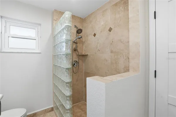 a bathroom with a shower toilet and sink