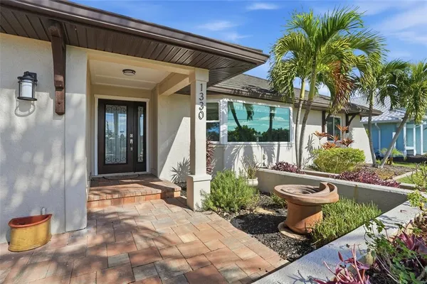 a view of a house with backyard sitting area and swimming pool