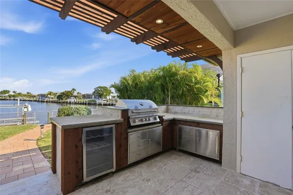 a open kitchen with stainless steel appliances granite countertop a stove and a shower