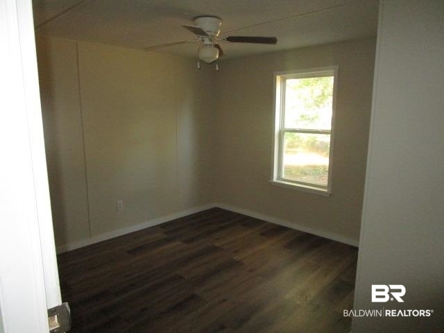 14791 Raber Road Summerdale, AL 36580 - Photo 16 of 21 Spare room featuring ceiling fan and dark hardwood / wood-style floors