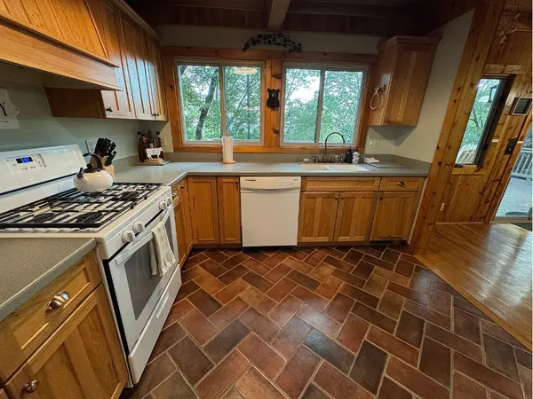a kitchen with a sink a stove a microwave and cabinets