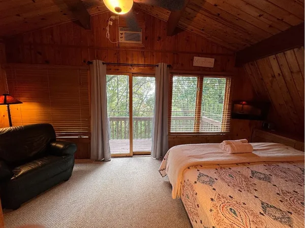 a bedroom with a bed and a couch