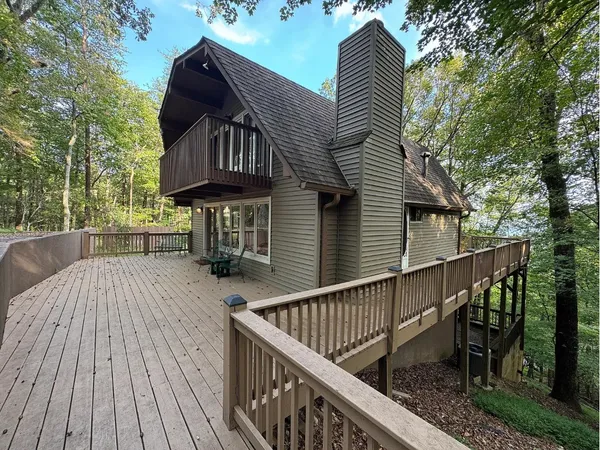 a view of balcony with wooden floor and fence