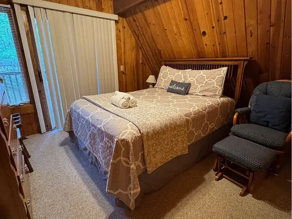 a bedroom with a bed and a mirror