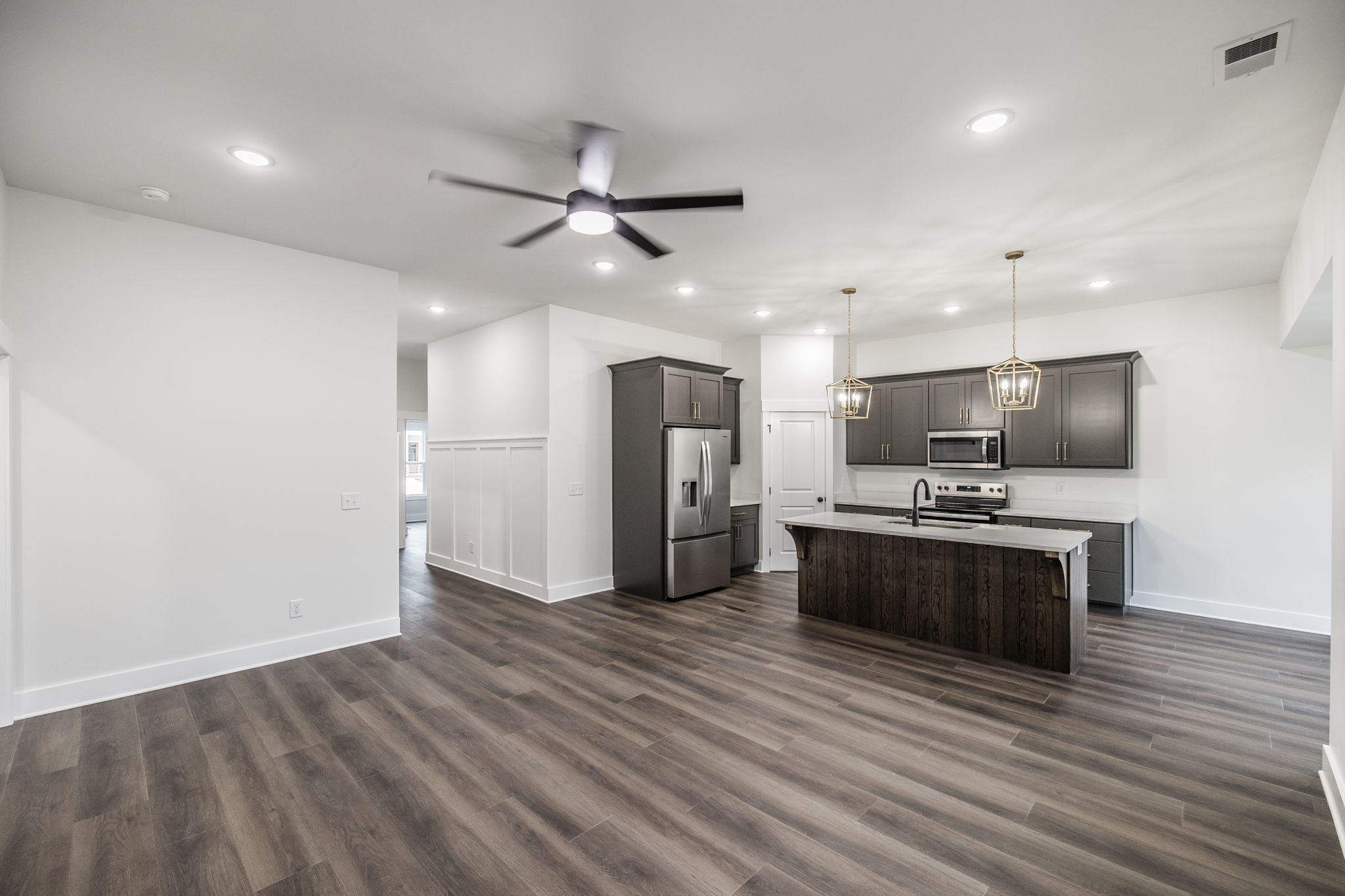 2157 Rylee Way Greenbrier, TN 37073 - Photo 13 of 35 a large kitchen with stainless steel appliances kitchen island a large counter top and wooden floors