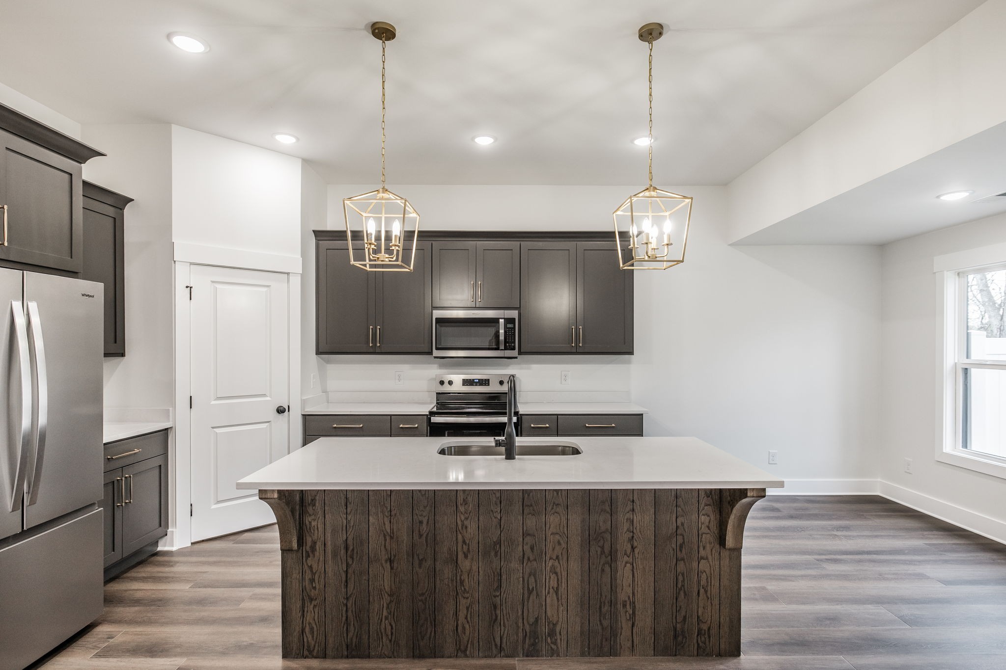2157 Rylee Way Greenbrier, TN 37073 - Photo 5 of 35 a kitchen with kitchen island granite countertop a sink refrigerator and microwave