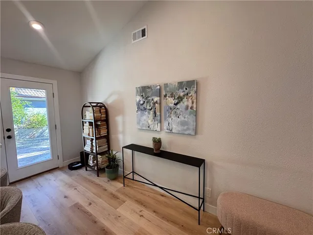 a view of a workspace with furniture and a window