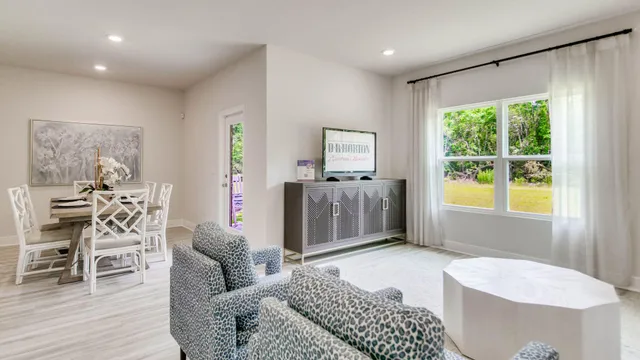 a bedroom with furniture and a large window