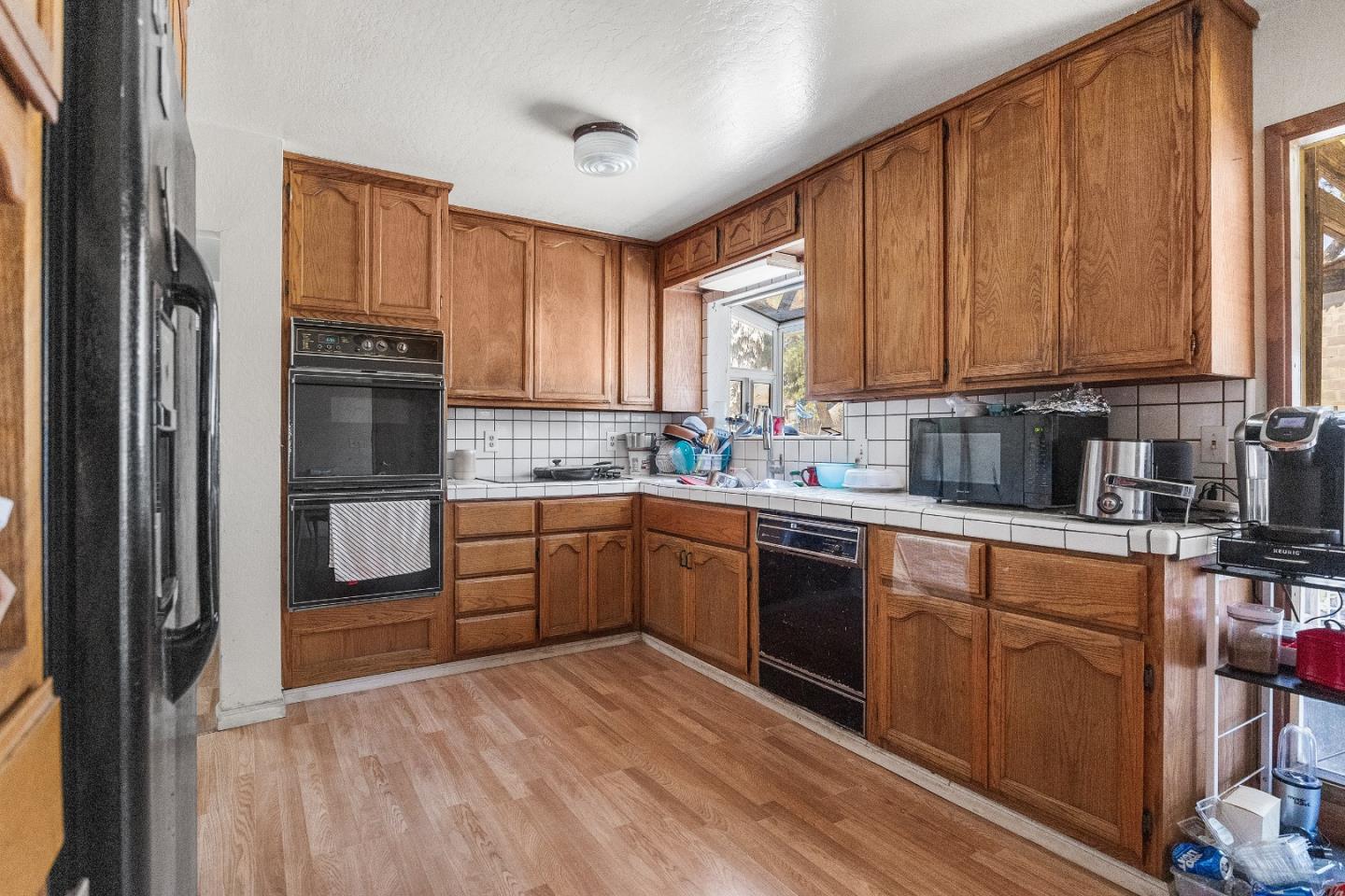 250 Old Chittenden Road Watsonville, CA 95076 - Photo 8 of 22 a kitchen with a refrigerator sink and cabinets