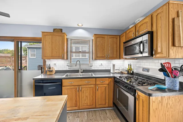 a kitchen with stainless steel appliances a sink stove top oven and cabinets