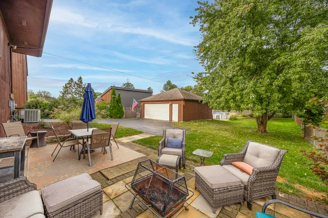 an outdoor space with patio chairs and a table