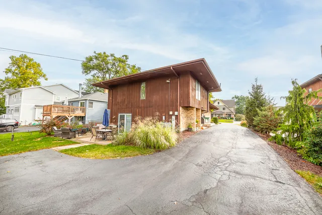 a view of a house with backyard and sitting area