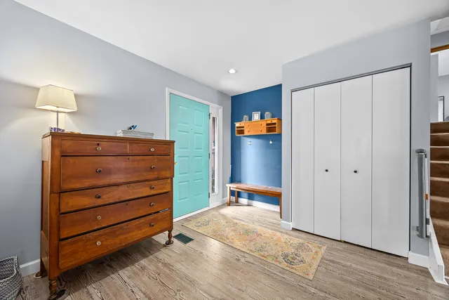 a view of walk in closet with hardwood wall