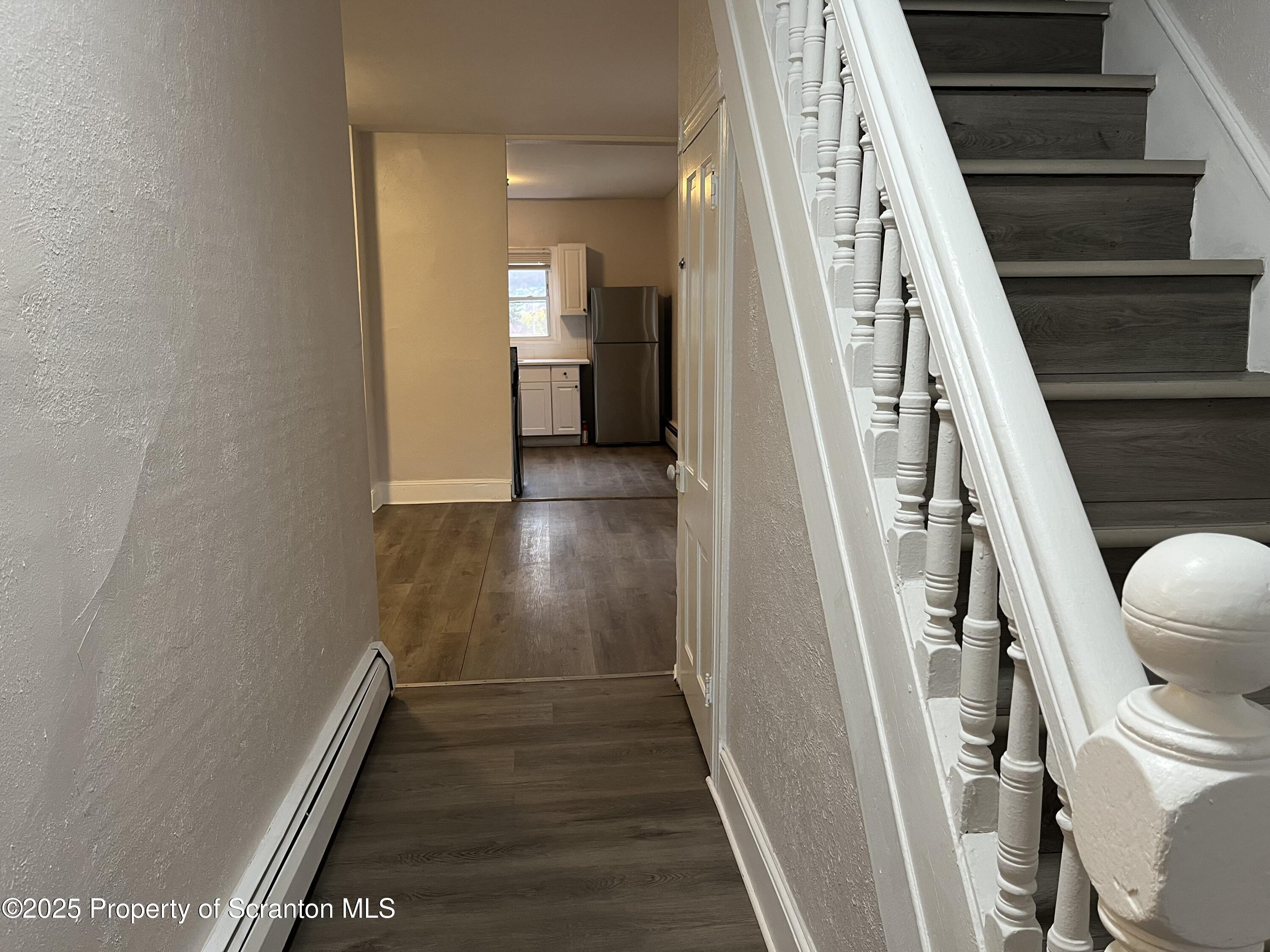 315 Aswell Court Scranton, PA 18504 - Photo 8 of 17 a view of a hallway with wooden floor and staircase