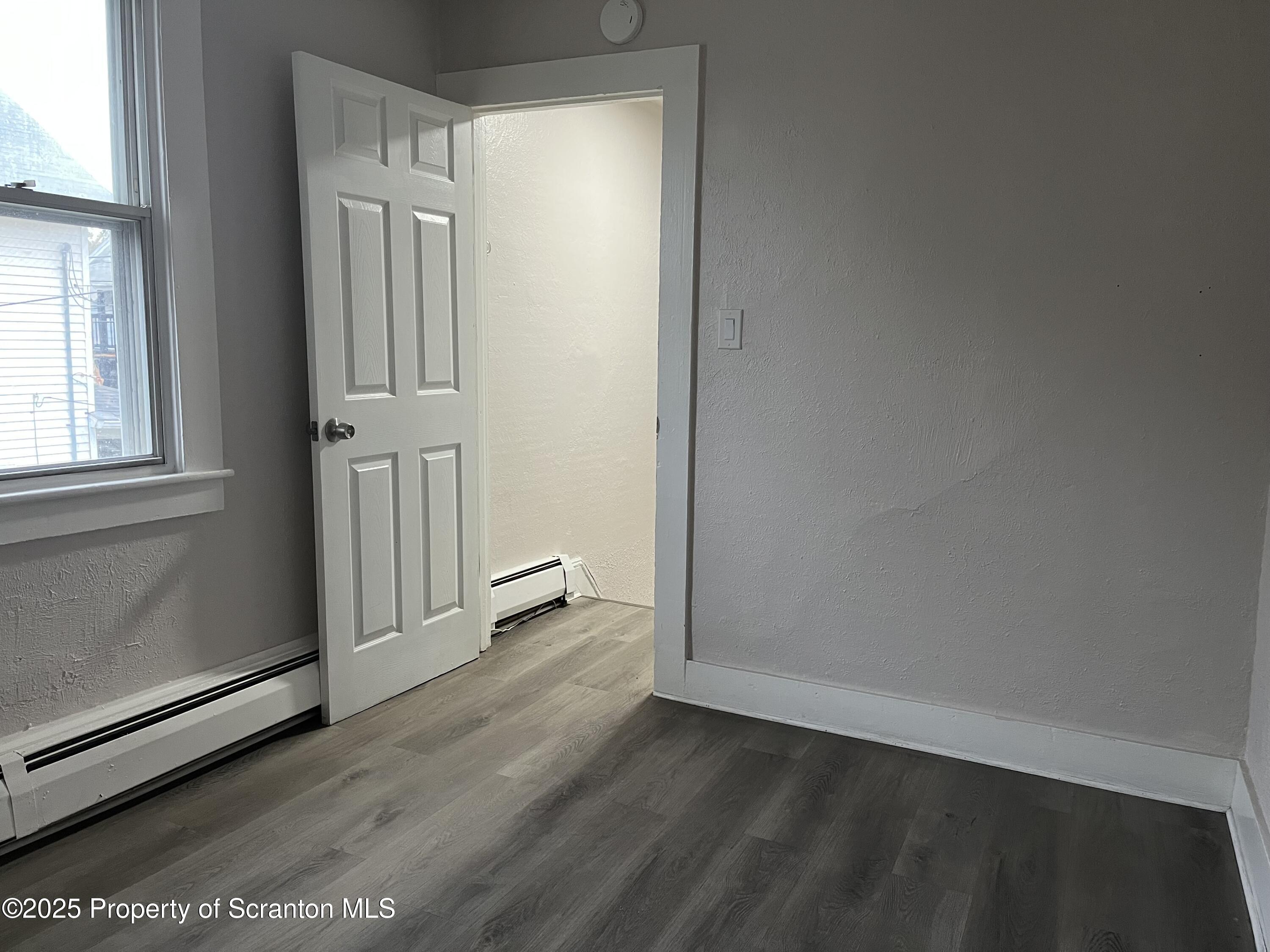 315 Aswell Court Scranton, PA 18504 - Photo 9 of 17 an empty room with wooden floor and windows