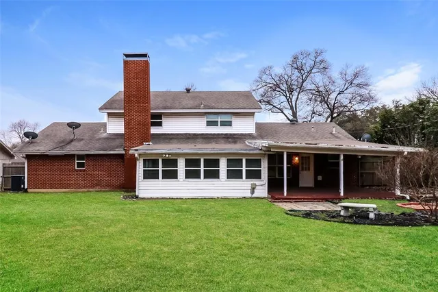 a front view of a house with a garden and plants