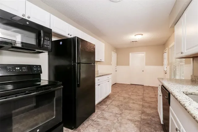 a kitchen with a refrigerator stove and microwave