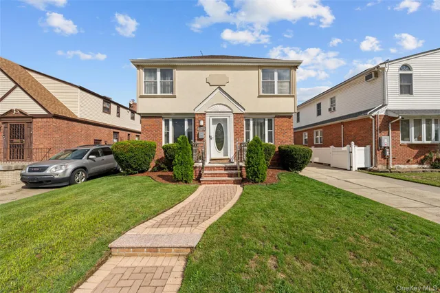 a view of a big house with a big yard and large trees