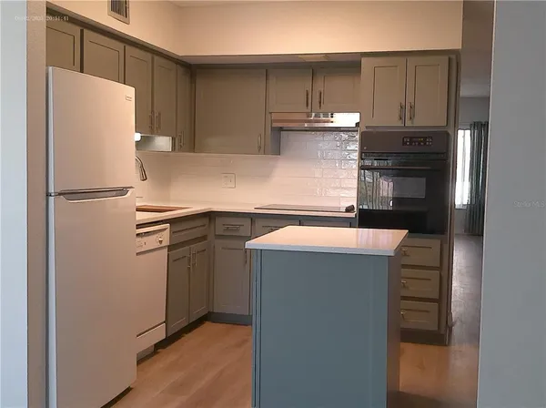 a view of a kitchen cabinets and wooden floor