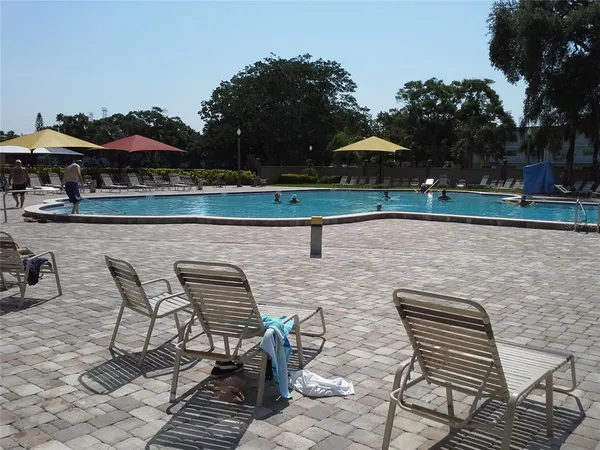 a view of a swimming pool with a yard