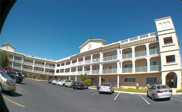 a view of empty room with chandelier fan