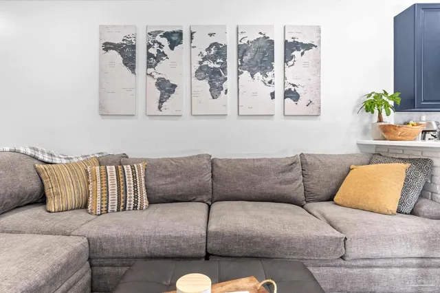 a living room with furniture and painting on the wall