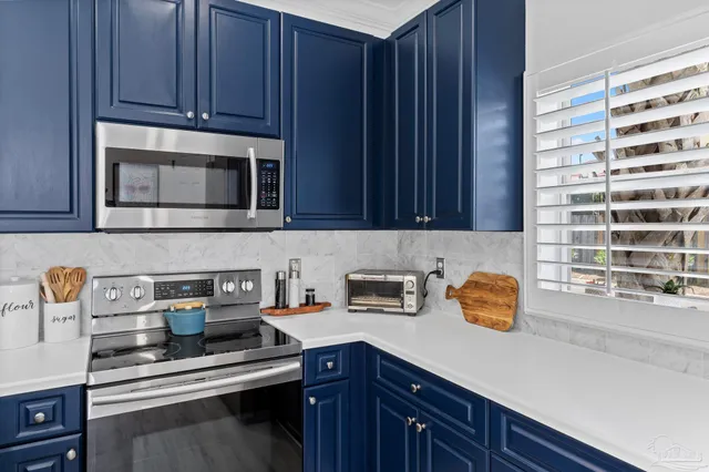 a kitchen with stainless steel appliances a stove a microwave and cabinets
