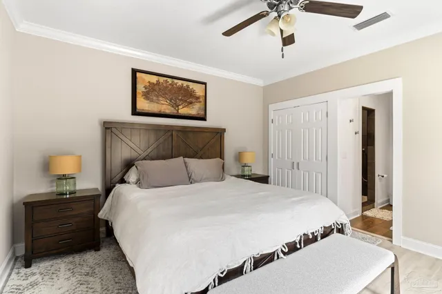 a bedroom with a bed and a chandelier