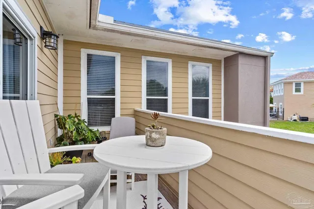 a view of an outdoor dining space with a table and chairs
