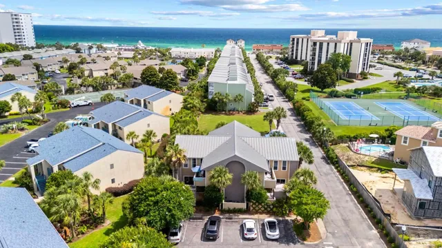 an aerial view of multiple houses with yard
